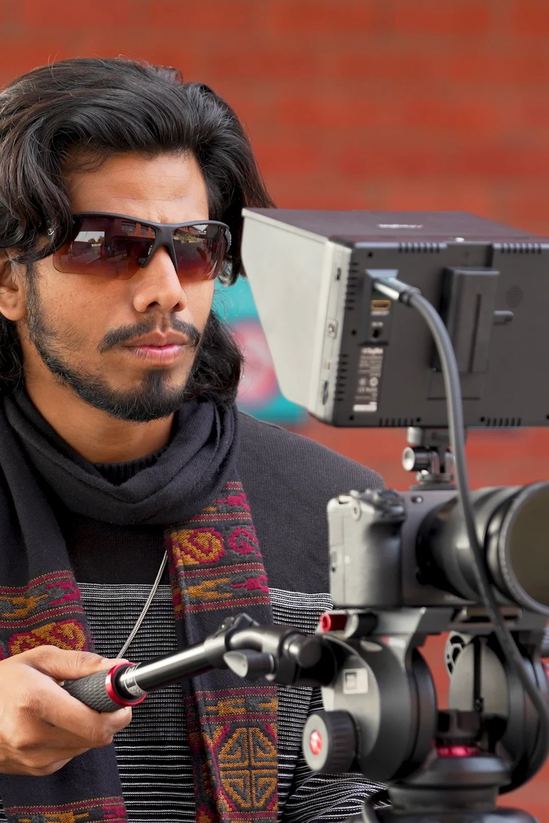 Film director handling professional cinema camera during shoot in Baramati Pune