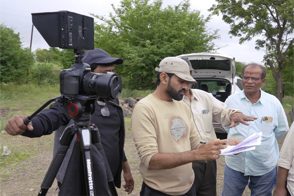 Cinera Films Studio team reviewing script and camera setup during on-location documentary shoot